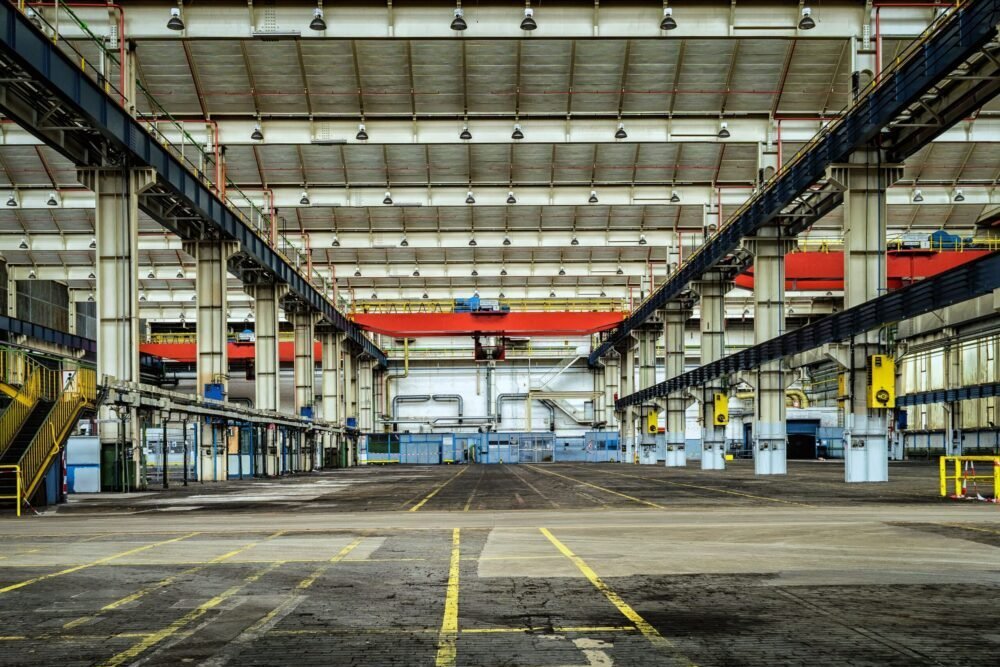 Expansive industrial warehouse interior showcasing steel framework and spacious layout for diverse manufacturing needs.